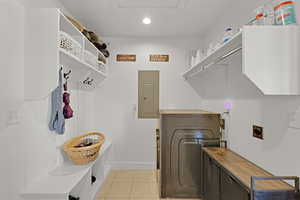 Laundry area featuring hookup for an electric dryer, electric panel, recessed lighting,