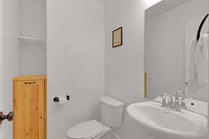 Half bathroom featuring a sink, toilet