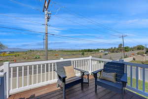 Deck with a mountain view and lake view off dining area