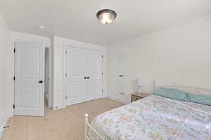 Bedroom with carpet flooring, a closet