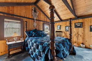 Bedroom featuring carpet floors, wooden ceiling, and wooden walls
