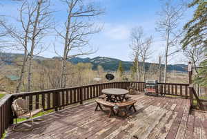 Wooden terrace featuring a mountain view