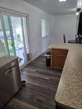 Dining room featuring dark wood-type flooring, ceiling fan, and baseboards