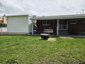 Back of property featuring entry steps and a patio area