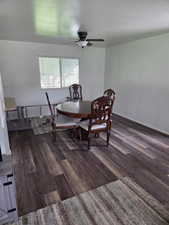 Dining room featuring ceiling fan, wood finished floors, and baseboards