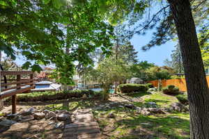 View of yard with fence and a wooden deck