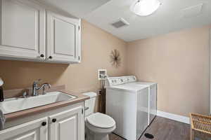 ADU Laundry room featuring separate washer and dryer and half bath