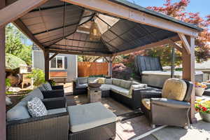 View of patio / terrace with a gazebo, an outdoor hangout area, and fence