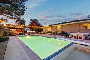 Outdoor pool featuring an outdoor living space, a gazebo, a patio area, and a diving board