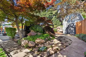 View of yard featuring a patio area, fence, and an outdoor structure