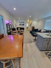 Dining room with light wood-style floors and recessed lighting