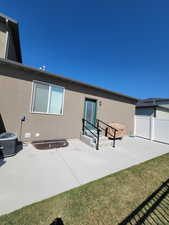 Rear view of property with fence, a patio, stucco siding, and cooling unit