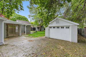 Detached garage with fence and driveway