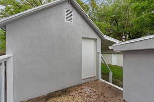 View of side of property with stucco siding and a patio