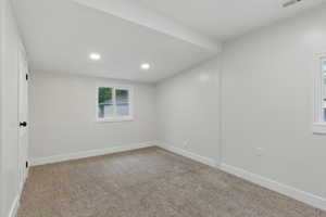 Spare room featuring recessed lighting, carpet flooring, and baseboards