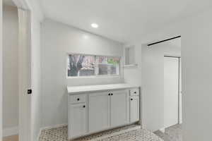 Kitchen featuring open shelves, light countertops, white cabinets, recessed lighting, and baseboards