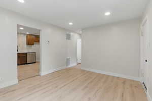 Unfurnished room with recessed lighting, light wood-style floors, and baseboards