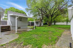 View of yard with an outbuilding and a wooden deck