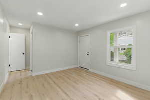 Spare room with baseboards, recessed lighting, and light wood-type flooring