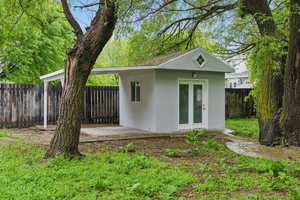 View of outbuilding featuring a fenced backyard and an outbuilding