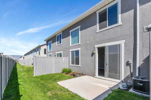 Back of house with a patio, central AC, and stucco siding