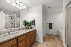 Primary bathroom with double sinks, separate soaking tub and shower