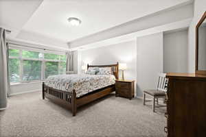 Primary bedroom upstairs with walk-in closet, ensuite bath, and access to deck