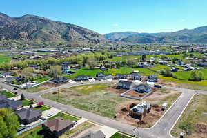 Aerial perspective of suburban area featuring a mountain backdrop
