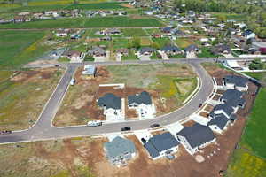 Aerial view of property and surrounding area with nearby suburban area