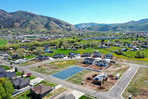 Aerial perspective of suburban area featuring a mountain backdrop