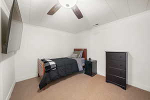 Bedroom with light colored carpet, baseboards, and crown molding
