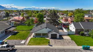Aerial perspective of suburban area featuring a mountainous background