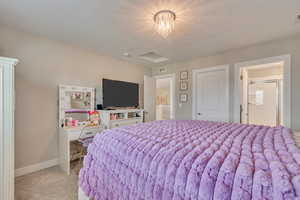 Bedroom featuring light carpet and baseboards