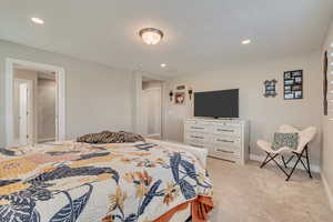 Bedroom featuring baseboards, light colored carpet, and recessed lighting