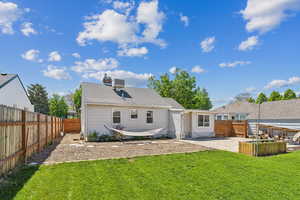 Back of property with a patio, a garden, and a chimney