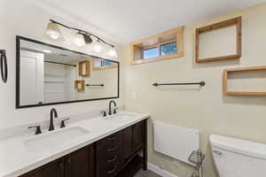 Bathroom with toilet and double vanity