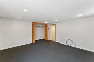 Unfurnished bedroom with recessed lighting, baseboards, and a closet