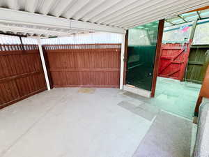 View of patio featuring fence