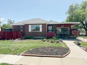 Bungalow-style home featuring brick siding and roof with shingles