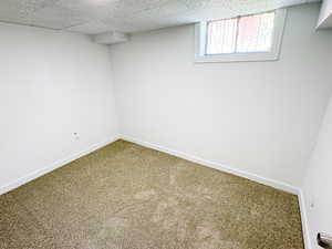 Below grade area with carpet floors and baseboards