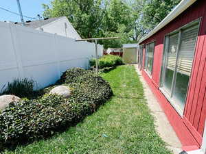 View of yard featuring a storage shed and an outbuilding