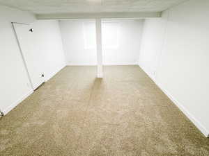 Finished below grade area featuring carpet flooring and baseboards