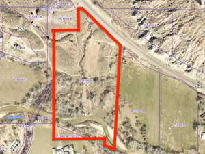 Aerial map of property and surrounding area featuring property parcel outlined