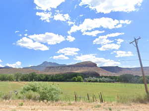 View of mountain background featuring rural landscape