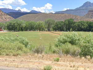View of mountain background featuring rural landscape