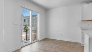 Unfurnished dining area featuring light wood-style floors and baseboards