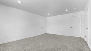 Unfurnished room featuring recessed lighting, carpet floors, baseboards, a smoke detector, and a textured ceiling