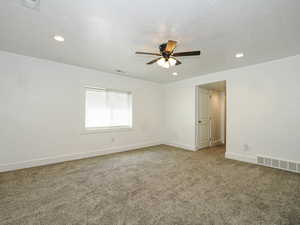 Spare room featuring a ceiling fan, carpet floors, recessed lighting, and baseboards
