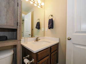 Half bath with vanity and toilet