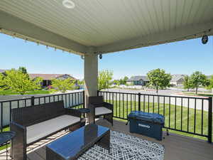 Wooden terrace featuring a residential view, an outdoor hangout area, and a lawn